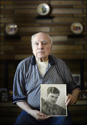 Billy Power holds a photo of Cpl. Harold W. Reed, who was killed in 1950 in the battle at Chosin Reservoir. Mr. Power too served in Korea and had promised Corporal Reed that he’d bring him home.