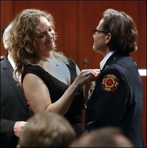 Sierra Hillebrand pins newly promoted Deputy Assistant Chief Karen Marquardt during the promotion ceremony. 