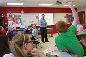 Lane Hakel, a sixth-grade social studies teacher at Bowling Green Middle School, listens to a comment made by Elijah Reinhart, 12.