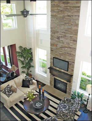 The dramatic stone fireplace rises two stories in the great room. 