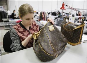Jenna Starr inspects a pair of Louis Vuitton handbags to authenticate them and make sure they meet brand standards at the headquarters of The RealReal in San Francisco. Other Web sites are helping shoppers resell their items faster, make more money, or buy upscale brands at a discount.