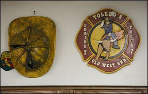 A captain’s helmet and logo of Station 7 adorn a wall in the kitchen of the firehouse.