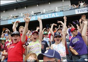 Washington Local Schools’ Monac Elementary students cheer the Toledo Mud Hens at Fifth Third Field during an outing with other fourth graders from the area.