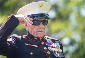 Retired Marine Cpl. Don Mooney salutes the casket of Cpl. Harold Reed. Mr. Mooney’s battalion helped rescue those still alive or dead during the Korean War.