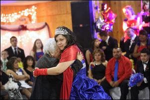 Both Lucie Perales, 78, center left, and her granddaughter, Quinceanera Brittney Rios shed tears as they dance together during the reception.