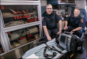 Firefighters/paramedics Mike Street, left, and Stefan Tiell are an ambulance team out of Firehouse No. 1 in Sylvania. Pri­vate am­bu­lances were un­avail­able for 5.7 per­cent of the township’s calls.