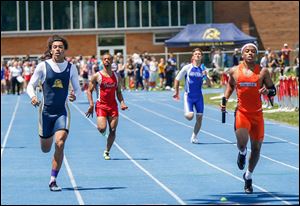 Malcolm Johnson, right, helps Southview win the 800-meter relay. He also won the 100, 200, and was on the winning 400-relay team.
