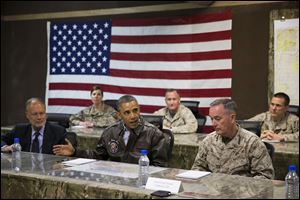 President Barack Obama, center, is briefed by Marine General Joseph Dunford, commander of the US-led International Security Assistance Force (ISAF), right, and US Ambassador to Afghanistan James Cunningham.