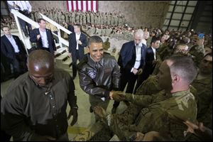 President Obama shakes hands at a troop rally at Bagram Air Field, north of Kabul, Afghanistan, during an unannounced visit Sunday.