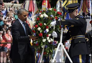 President Obama lays a wreath at the Tomb of the Unknowns at Arlington National Cemetery in Arlington, Va.