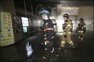 South Korean firefighters arrive at a bus terminal at Goyang, north of Seoul, South Korea, today.
