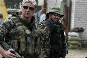 Members of Ukrainian national guard get ready for action at their base in Starobelsk, Luhansk region, eastern Ukraine, Sunday.