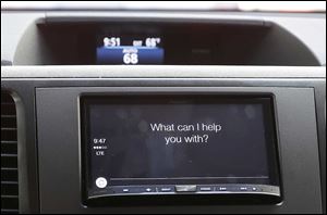 The new Apple CarPlay powered by Pioneer, asks a driver a question during a demonstration in San Francisco. Utilizing large, in-dash Pioneer LCD displays, CarPlay, featuring Siri voice control, gives iPhone users the features while allowing them to stay focused on the road. 