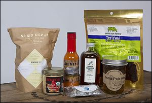Glenwood Garden sells artisan foods online and shares the profits with nonprofit organizations. Shown here are the products included in the company’s Father’s Day-themed food box. 