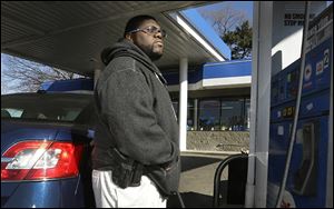 Greg Champion wears a gun while pumping gas in Detroit. To avoid becoming a carjacking victim, Mr. Champion wears a handgun on his hip whenever he is pumping gas. Through May 19, Detroit has recorded 191 carjackings in 2014.