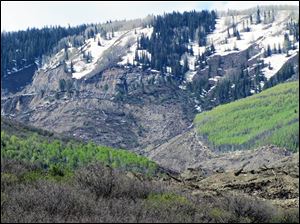 The results of a three-mile long mudslide appear on Grand Mesa, where the slide started, in a remote part of western Colorado near the small town of Collbran Monday.