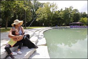 Diana Bradley and her grand daughter Kamilah Asad, 3,Toledo, try their luck fishing at Pearson Metropark Preserve last August.