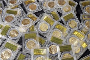 Some of the 1,427 Gold-Rush era U.S. gold coins are displayed at Professional Coin Grading Service in Santa Ana, Calif. A treasure trove of rare gold coins was discovered by a California couple out walking their dog.