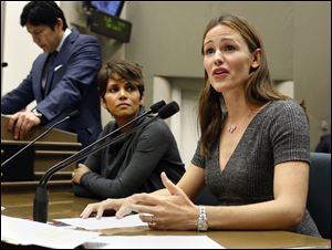 Actress Jennifer Garner, right, describes how paparazzi aggressively follow her and her three children daily, while testifying before the Assembly Judiciary Committee at the Capitol in Sacramento, Calif., in August. At left is actress Halle Berry.