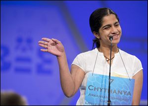 Eighth grader Chythanya Murali, 13, of LISA Academy West, Little Rock, Ark., waves and greets the judges, during the preliminaries, round two of the Scripps National Spelling Bee today at National Harbor in Oxon Hill, Md. Murali, spelled her word ocelot correct.  