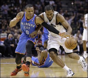 Oklahoma City’s Russell Westbrook, left, and San Antonio's Kawhi Leonard chase a loose ball during the first half of Game 5 on Thursday night.