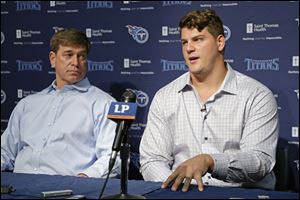 Tennessee Titans top draft pick Taylor Lewan, right, an offensive lineman from Michigan, answers questions with general manager Ruston Webster, left, at a news conference earlier this month.