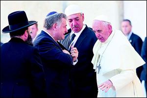Pope Francis talks with, from left, Rabbi of the Western Wall Shmuel Rabinovitch, Argentine Rabbi Abraham Skorka, and Argentine Muslim leader Omar Abboud, during his visit at the Western Wall.