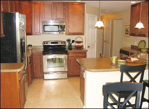 The efficient kitchen includes a peninsula snack bar, open to the great room.