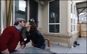 Dave Mullins, right, kisses his husband Charlie Craig. The couple filed a legal complaint with the Colorado Civil Rights Commission against Denver-area baker Jack Phillips, who refused to make a wedding cake for the two men, citing his religious beliefs.