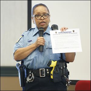 Dana Slay, one of nine Toledo police community services officers in the department, discusses information available through the Neighborhood Block Watch during a community forum.