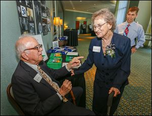 Dr. Peter White, left, professor emeritus, chats with Annabelle Isaacs, the first employee at the Medical College of Ohio, during the 50th anniversary celebration of its founding. At right is medical student Jonathan Demeter of Springfield, Ohio.