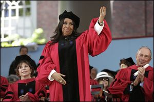 Singer Aretha Franklin receives an honorary doctor of arts degree as Chilean author Isabel Allende, left, and former mayor of New York City, Michael Bloomberg, look on at Harvard’s commencement.