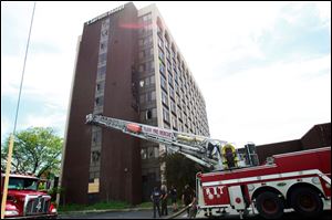 Fire crews stand by at the closed Clarion hotel on Reynolds Road in South Toledo after a fire broke out on June 1.