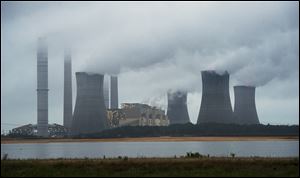The coal-fired Plant Scherer is shown in operation early Sunday in Juliette, Ga.