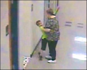 A Riverdale teacher, Barb Williams, has been suspended for 10 days after a security camera showed her pushing the student against a wall and then lifting him up by his shirt and face. 