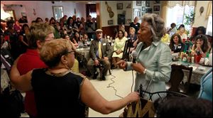 Joyce Beatty, member of Congress from Columbus, right, talks to Ruby Butler, center. Ruby, owner of Ruby's Kitchen, has her arm around Congresswoman Marcy Kaptur.