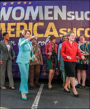 U.S. Rep. Nancy Pelosi (D., Calif.), front left, and Rep. Marcy Kaptur (D., Toledo), front right, accompany other representatives to promote women’s success.