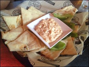 Hot Feta Dip Big Crock of Spiced Hot Whipped Feta Dip along with Sliced Green Peppers and Warm Fresh Flatbread