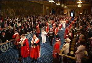 Britain's Queen Elizabeth II, center left,  and Prince Philip, center right,  proceed through the Royal Gallery during the State Opening of Parliament in the House of Lords at the Palace of Westminster in London. 