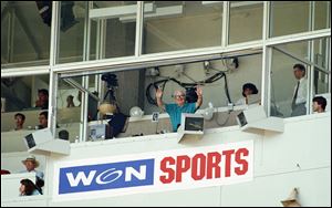 In this July 22, 1994, file photo, Harry Caray waves from the broadcast booth before the Chicago Cub's game against the Cincinnati Reds in Chicago at Wrigley Field. 