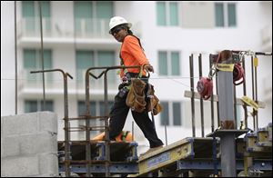 A construction worker works on the site of the SoMa at Brickell apartment building in downtown Miami.