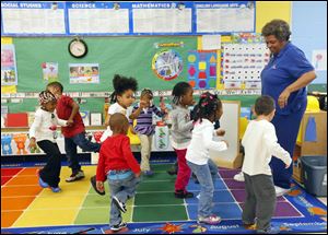 Linda Jefferson, the former  Toledo Troopers football player, leads her Head Start class in a movement exercise during an afternoon class in March.