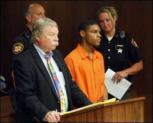 Attorney James McHarg, left, stands with Samuel Oliver, 21, who was charged with aggravated murder, during Oliver's arraignment.