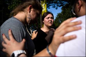 Following the lift of a lockdown in the wake of a school shooting, Seattle Pacific University students pray together.