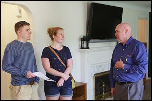 Adam Bachorik, left, and Erica Davis, both of West Toledo, talk with RE/MAX Realtor Jack Schroeder during an open house Mr. Schroeder was showing a West Toledo home listed for $149,000.