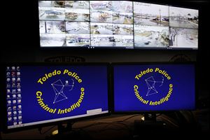 Video cameras display areas of the city in the Toledo Police Department’s real-time crime center at the Safety Building. These feeds have alerted police officers and led to crews being sent to crime scenes. 