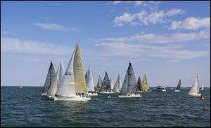 Boats competing in the President’s Trophy Course cross the start line at the Toledo Harbor Light for the Mills Trophy Race. 