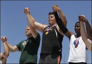 Liberty Center’s Nick Demaline, center, won the Division III shot put with a heave of 66 feet, 3½ inches on Friday in Columbus.