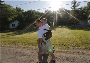 Hunter Gandee, 14, and his brother Braden, 7, begin the trek to Ann Arbor.