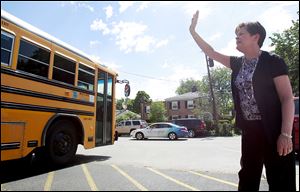 Barbara Jenks, retiring principal at St. Rose School, waves to students as they leave school for summer vacation. Mrs. Jenks has seen many students go from kindergarten to high school in 21 years. 